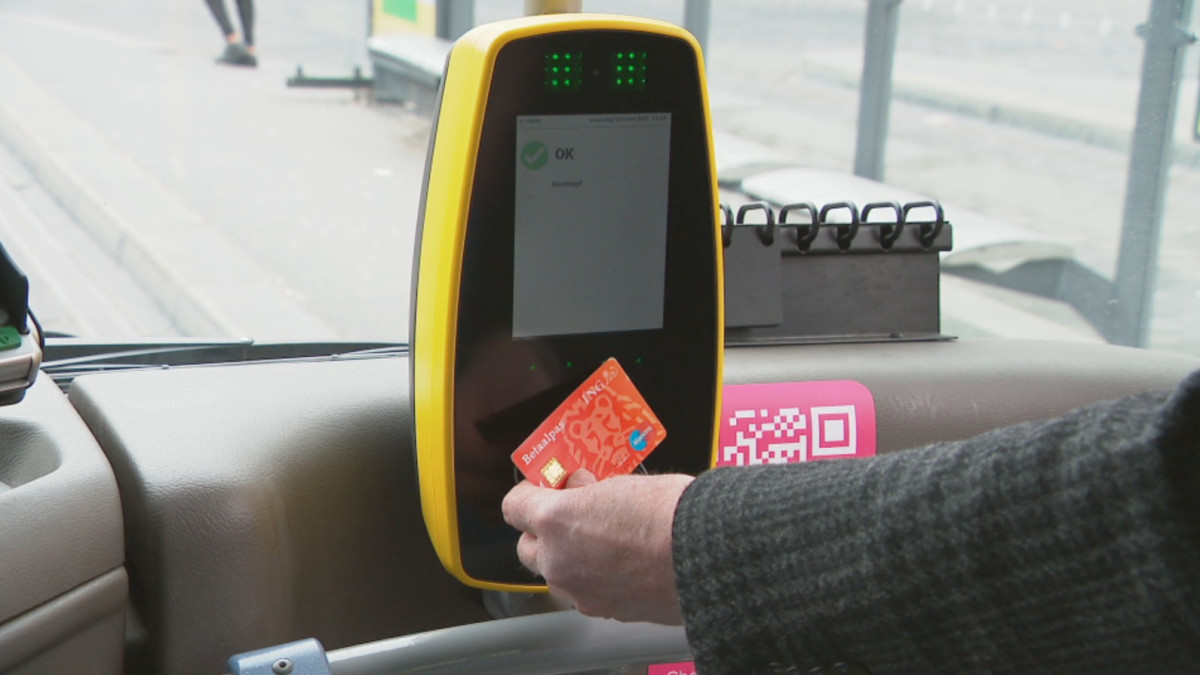 Buspassagier die betaalt met pinpas, ter illustratie